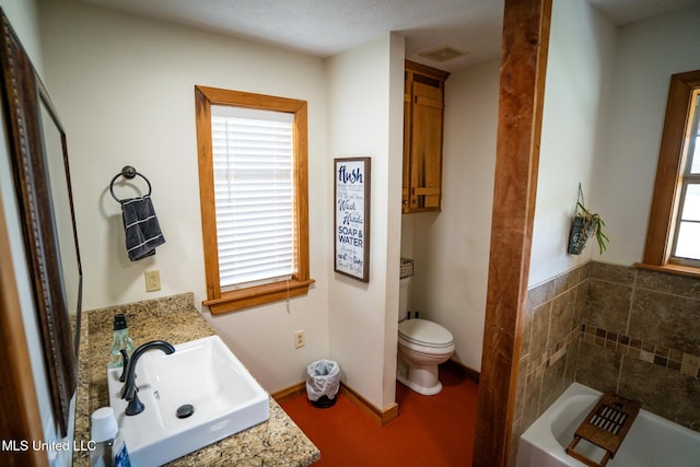 full bath with visible vents, toilet, a washtub, baseboards, and vanity