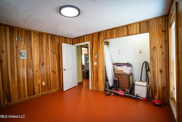 miscellaneous room featuring wooden walls