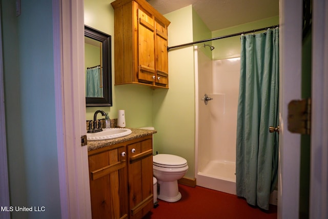 bathroom featuring vanity, a shower with shower curtain, and toilet