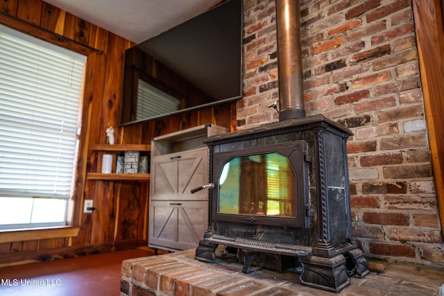 interior details featuring wooden walls and a wood stove