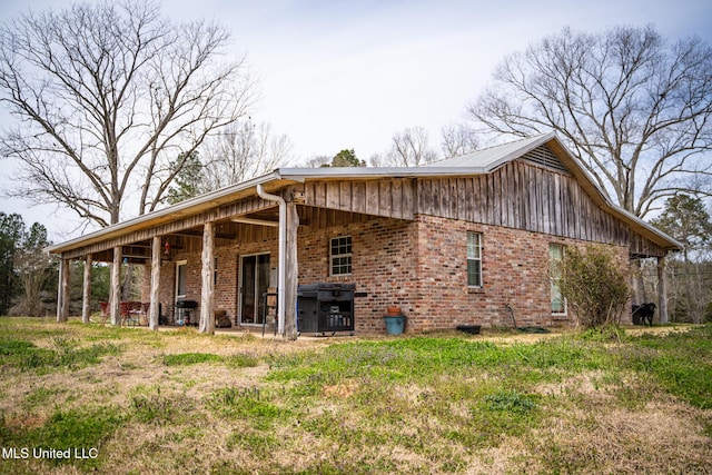 view of property exterior with brick siding