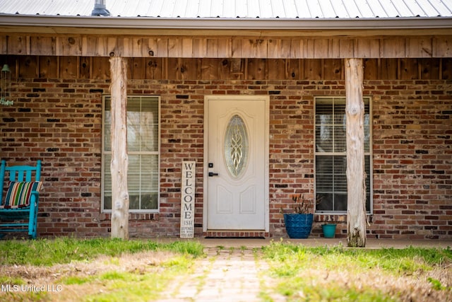 property entrance featuring brick siding