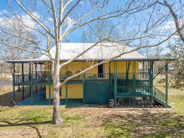 6132 Shawnee St, Kiln, MS 39556 - rear view of house with stairway, a metal roof, and a deck