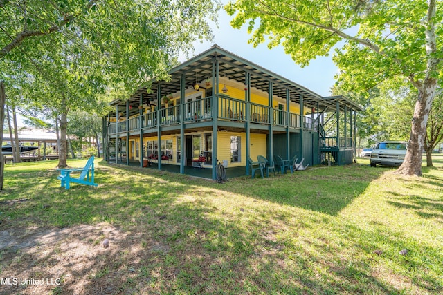 6132 Shawnee St, Kiln, MS 39556 - rear view of house featuring a yard
