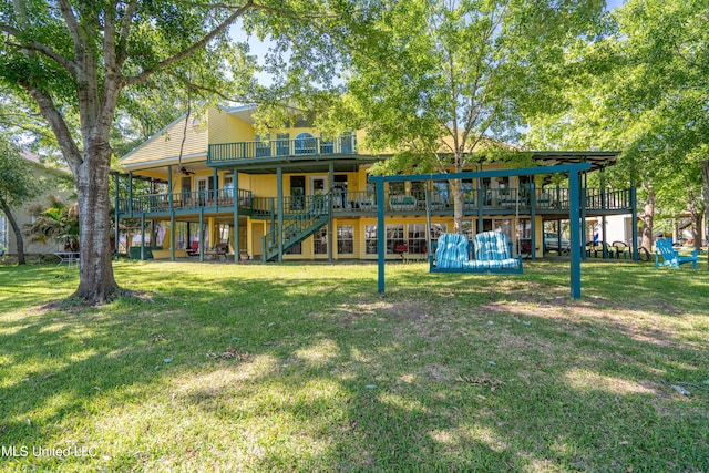6132 Shawnee St, Kiln, MS 39556 - back of house featuring stairway, a ceiling fan, a wooden deck, and a yard