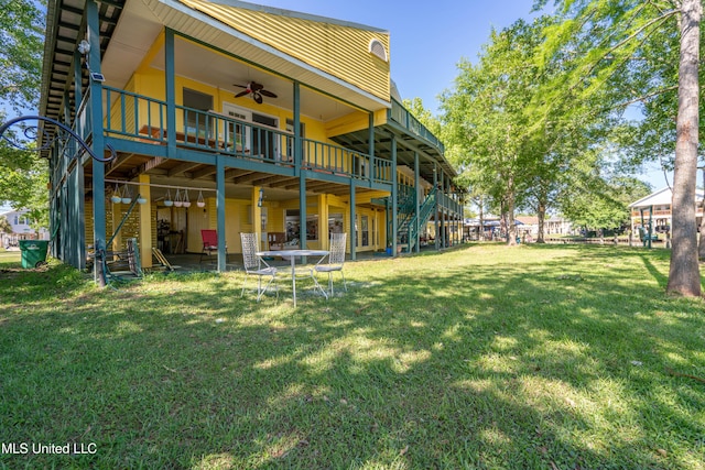 6132 Shawnee St, Kiln, MS 39556 - back of house featuring ceiling fan, a lawn, a wooden deck, and stairway