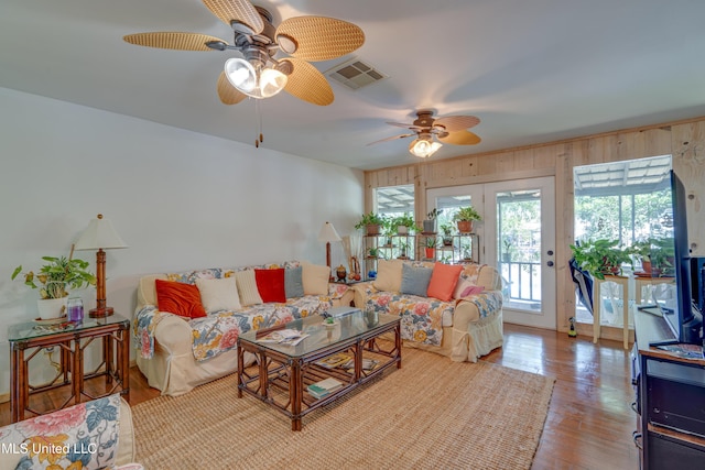 6132 Shawnee St, Kiln, MS 39556 - living room featuring a ceiling fan, wood finished floors, and wooden walls