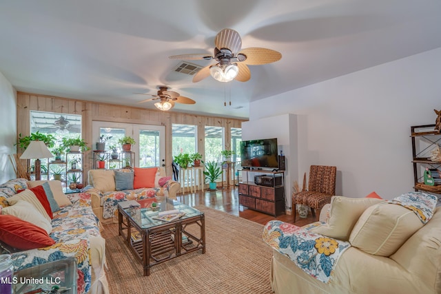 6132 Shawnee St, Kiln, MS 39556 - living area featuring ceiling fan, wood finished floors, and wood walls