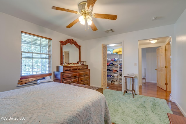 6132 Shawnee St, Kiln, MS 39556 - bedroom with wood finished floors, a closet, and ceiling fan