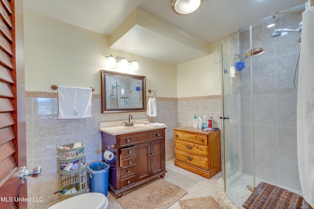 6132 Shawnee St, Kiln, MS 39556 - full bathroom featuring tile walls, a stall shower, vanity, tile patterned flooring, and a wainscoted wall