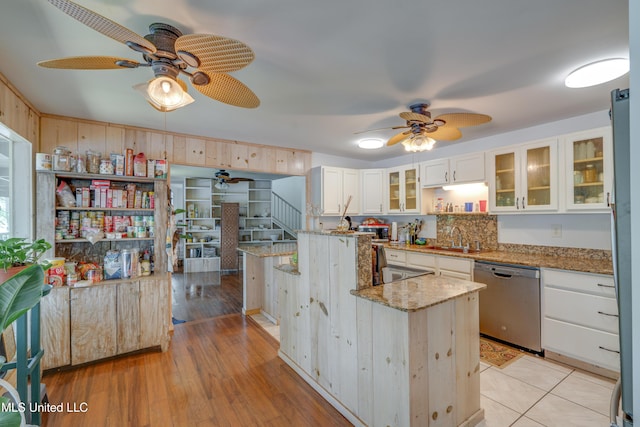 6132 Shawnee St, Kiln, MS 39556 - kitchen featuring stainless steel dishwasher, ceiling fan, white cabinetry, and light stone countertops