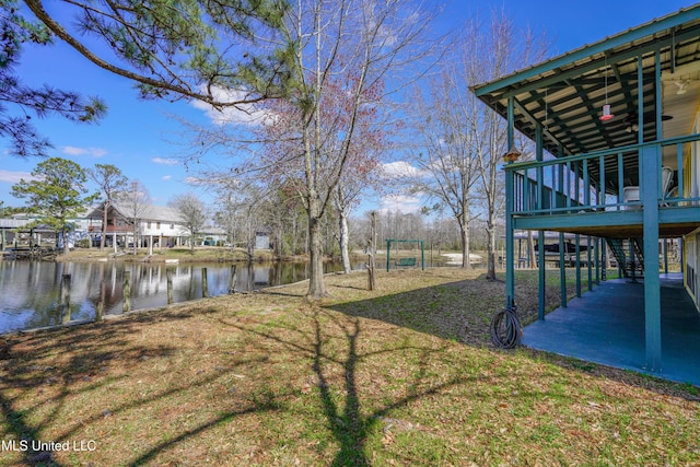6132 Shawnee St, Kiln, MS 39556 - view of grassy yard with stairs and a deck with water view