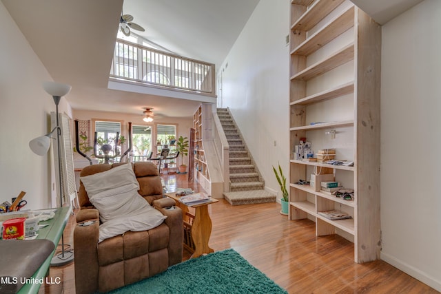 6132 Shawnee St, Kiln, MS 39556 - living room featuring a ceiling fan, stairway, wood finished floors, and high vaulted ceiling
