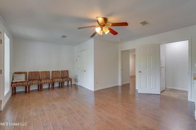 6132 Shawnee St, Kiln, MS 39556 - unfurnished room with a ceiling fan, wood finished floors, and ornamental molding