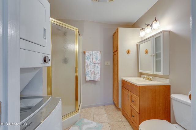 6132 Shawnee St, Kiln, MS 39556 - bathroom with estacked washer and dryer, a stall shower, vanity, and tile patterned flooring