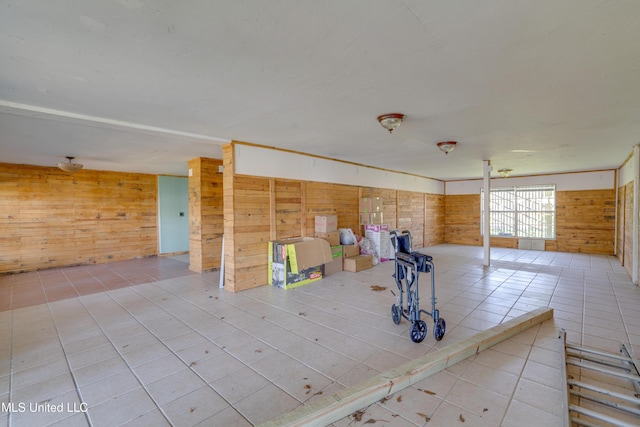 6132 Shawnee St, Kiln, MS 39556 - spare room featuring wood walls and tile patterned flooring