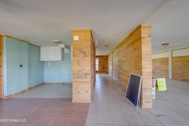 6132 Shawnee St, Kiln, MS 39556 - hallway with wooden walls and light tile patterned floors