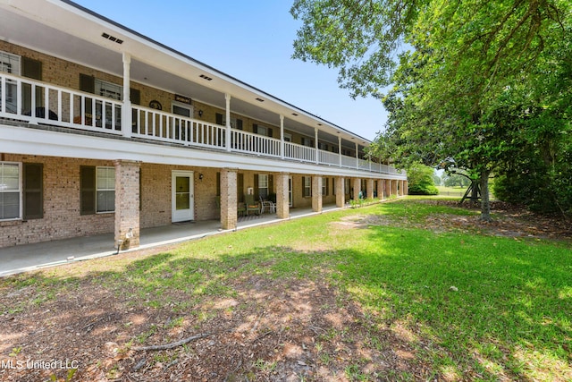 exterior space featuring a balcony and a patio