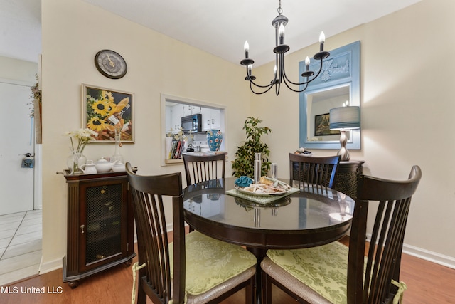 dining room with a notable chandelier and hardwood / wood-style flooring