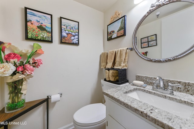 bathroom featuring toilet and vanity