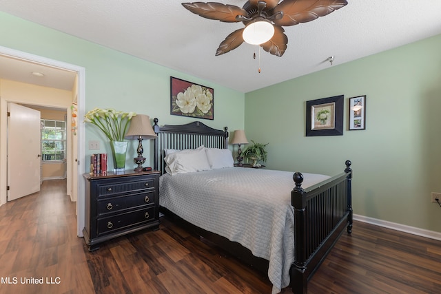 bedroom with ceiling fan, a textured ceiling, and dark hardwood / wood-style flooring