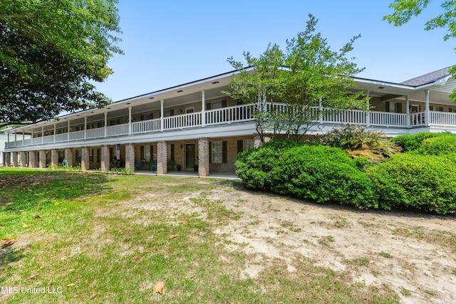 rear view of property featuring a lawn