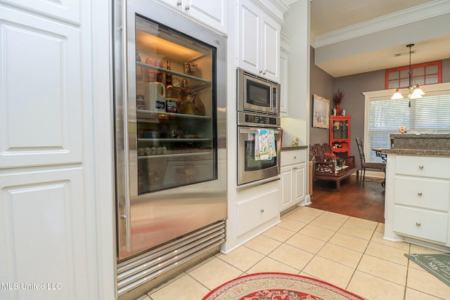 kitchen featuring light hardwood / wood-style flooring, ornamental molding, white cabinetry, stainless steel appliances, and a chandelier