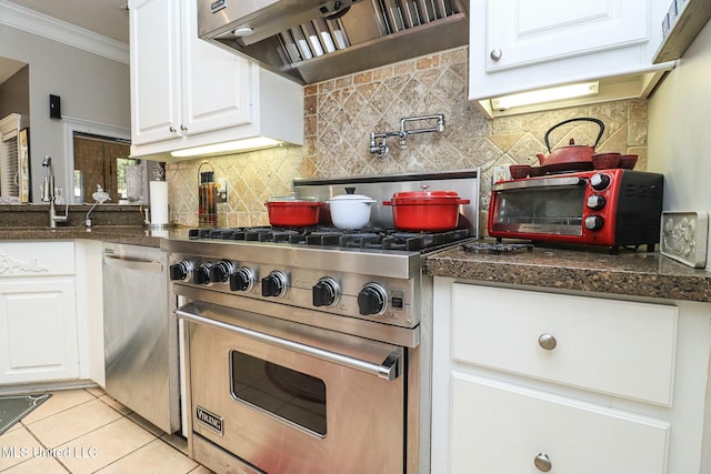 kitchen with white cabinetry, stainless steel appliances, tasteful backsplash, light tile patterned flooring, and ornamental molding