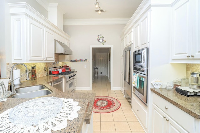 kitchen featuring sink, white cabinetry, stainless steel appliances, and wall chimney range hood