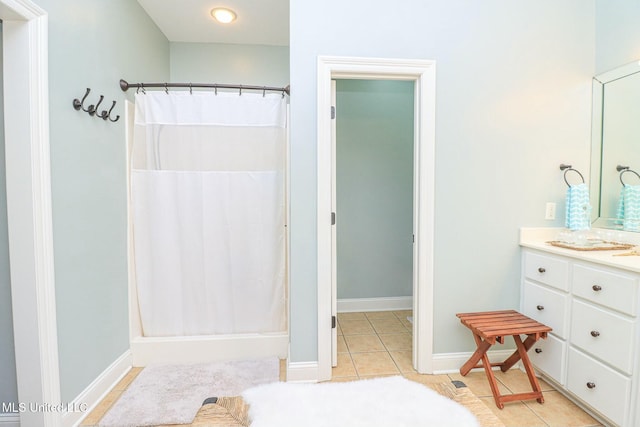 bathroom featuring a shower with shower curtain, vanity, and tile patterned floors