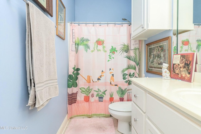 bathroom featuring tile patterned floors, vanity, toilet, and walk in shower