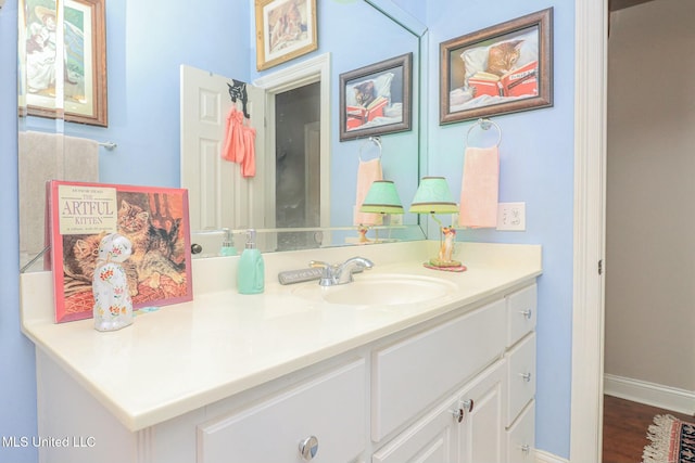 bathroom with hardwood / wood-style floors and vanity