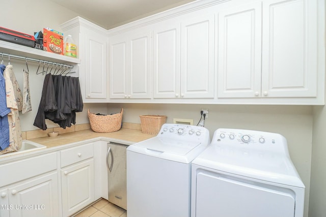 laundry room featuring cabinets, independent washer and dryer, and light tile patterned floors