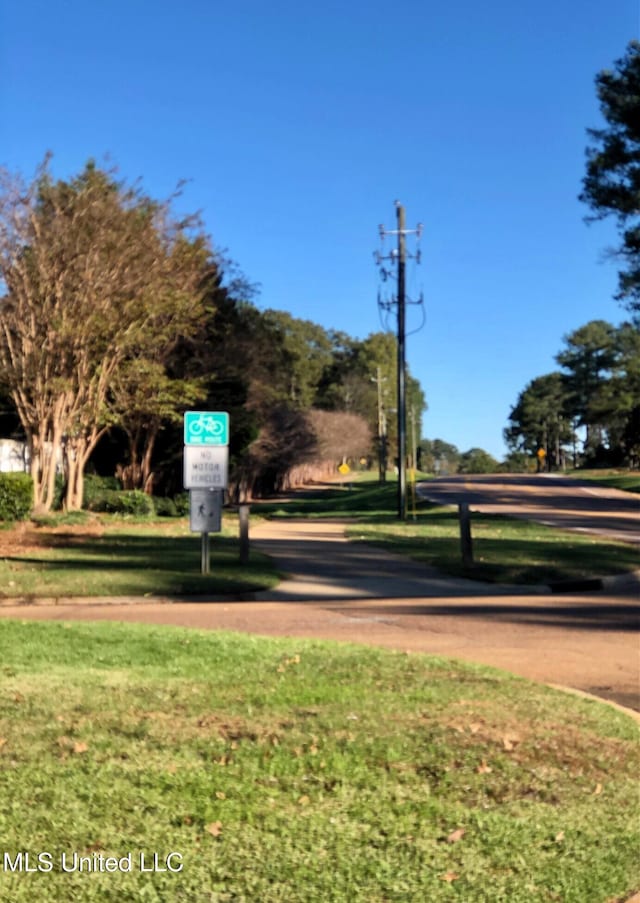 view of property's community with a lawn