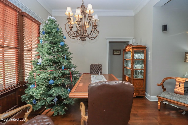 dining room with dark hardwood / wood-style floors, crown molding, and a chandelier