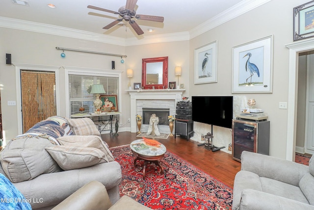 living room with hardwood / wood-style flooring, ceiling fan, ornamental molding, and beverage cooler