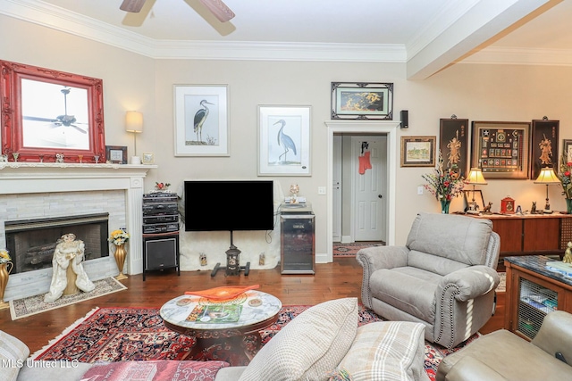 living room featuring dark wood-type flooring, a high end fireplace, ornamental molding, beamed ceiling, and beverage cooler