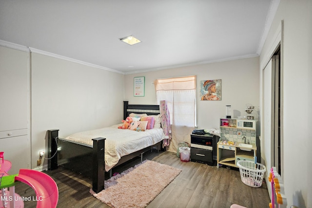 bedroom with wood-type flooring and ornamental molding