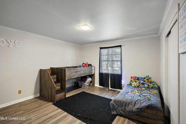 bedroom with hardwood / wood-style flooring and ornamental molding