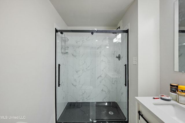 bathroom with vanity and a shower with door