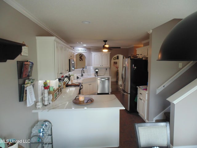 70 Tree Line Dr, Mount Pleasant, MS 38635 - kitchen featuring stainless steel appliances, a ceiling fan, light countertops, a peninsula, and white cabinetry