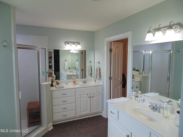 70 Tree Line Dr, Mount Pleasant, MS 38635 - full bath featuring a shower stall, two vanities, and tile patterned flooring