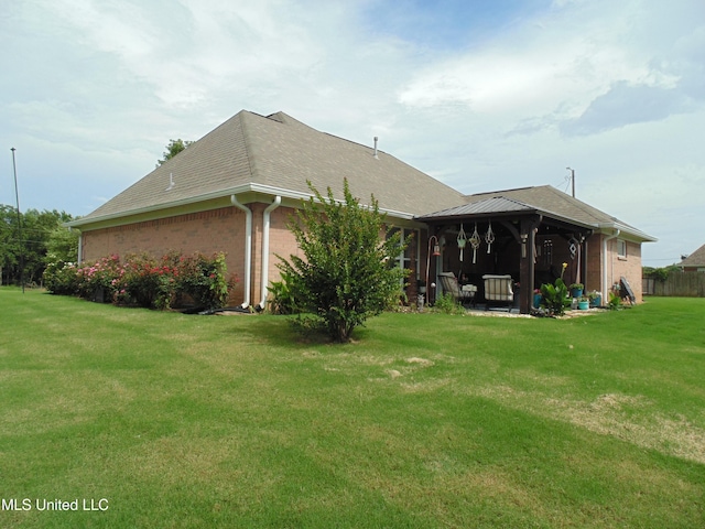 70 Tree Line Dr, Mount Pleasant, MS 38635 - rear view of house featuring a gazebo, a yard, brick siding, and roof with shingles