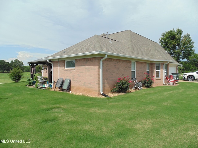 70 Tree Line Dr, Mount Pleasant, MS 38635 - view of home's exterior with a lawn, brick siding, and roof with shingles