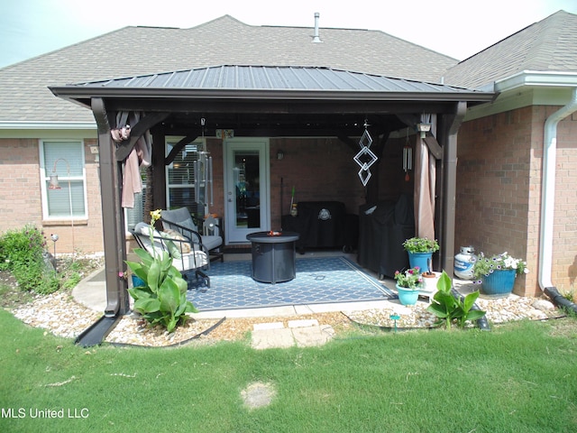 70 Tree Line Dr, Mount Pleasant, MS 38635 - rear view of property featuring brick siding, roof with shingles, a patio area, and a yard