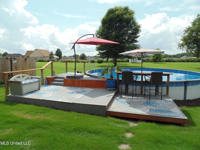 70 Tree Line Dr, Mount Pleasant, MS 38635 - wooden deck featuring an outdoor pool and a yard