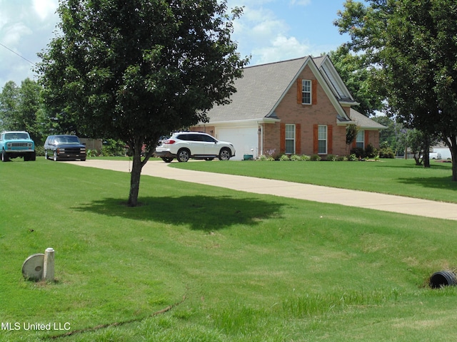 70 Tree Line Dr, Mount Pleasant, MS 38635 - view of front facade with brick siding, a front lawn, an attached garage, and concrete driveway