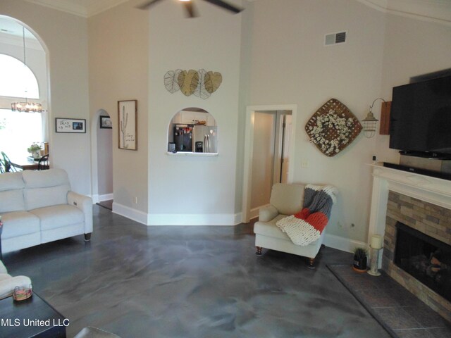 70 Tree Line Dr, Mount Pleasant, MS 38635 - living room with concrete floors, a fireplace, a high ceiling, ceiling fan, and a chandelier