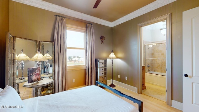 bedroom featuring ensuite bath, ceiling fan, light hardwood / wood-style flooring, and crown molding