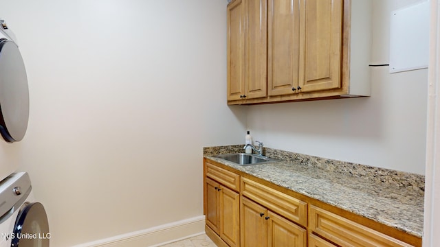 clothes washing area with cabinets, light tile patterned floors, sink, and washer / clothes dryer